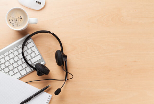 Office desk with headset and pc Office desk with headset and pc. Call center support table. Top veiw with copy space